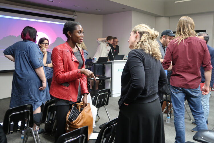 Woman talking to another woman at the end of a group meeting