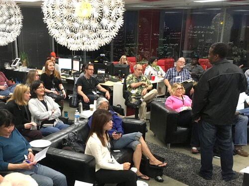 Group sitting in comfortable seats listening to a speaker