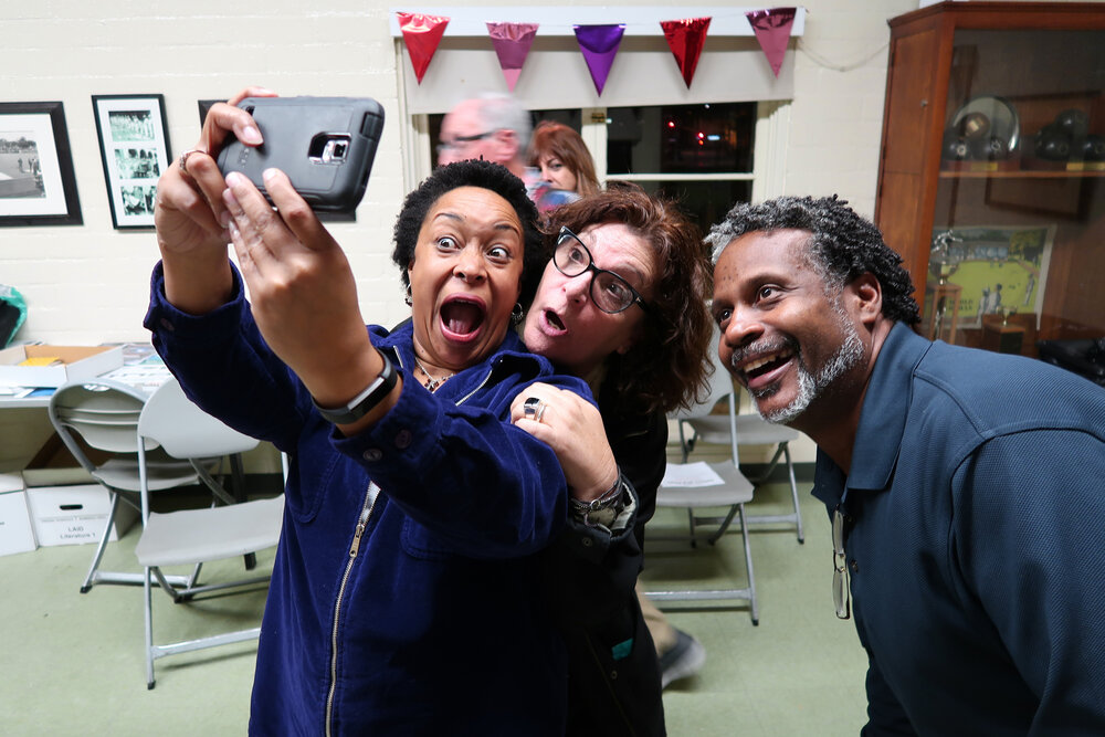 Woman taking a selfie with 2 others